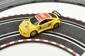 Yellow race car on a track, featuring "Repsol" and "SCX" decals for SCX Compact C10182X300