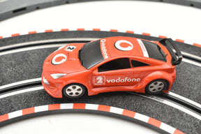 Red toy race car on track with Vodafone logo for SCX Compact C10183X300