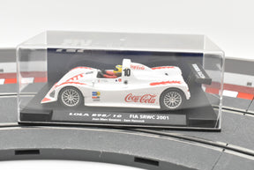 White race car model, Lola B98/10, displayed in a clear case for Fly Car Fia Srwc 2001