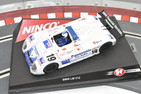 White BMW race car with blue and red accents on a black base for Ninco 50201