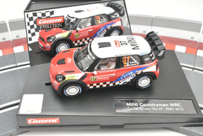 Red Mini Countryman WRC race car model on a display base for Carrera Evolution 27405
