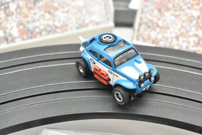 Blue VW Beetle race car on a black track, ready for action for Auto World SC012