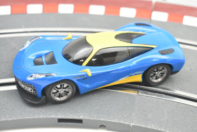 Blue and yellow race car model on a track surface for Scalextric C4141T