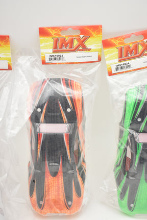 Orange and green monster truck bodies in packaging for Ninja Monster Truck IMX16923