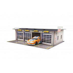 Model kit of a four-stall pit garage with a race car displayed for Innovative Hobby Supply BK4811