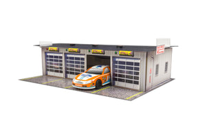 Model kit of a four-stall pit garage with a race car parked outside for Innovative Hobby Supply BK6411