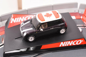 Miniature slot car with Canadian flag, displayed on a black base for REH Ninco 50309