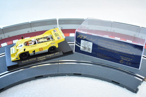 Yellow slot car of a 1972 Porsche 917/10 race car on a track section for Fly Car 88014