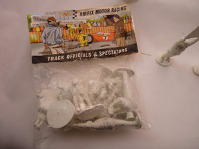 Unpainted plastic figures: motor racing track officials and spectators for AIRFIX