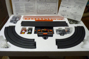Race set components including track pieces, control center, and instruction manuals for Aurora Tomy AFX Vintage 8607M