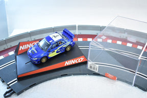 Blue Subaru WRC 2006 slot car on a track section for ZZ Expired Kim Collection 50431, track view
