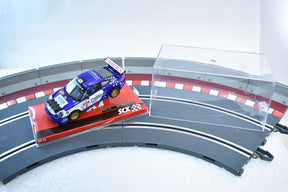 Blue Porsche 911 GT3 Rally car on a track section for SCX Analog A10159X3U0