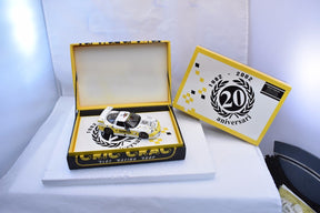 Yellow slot car in open box with anniversary commemorative card for Fly Car E123