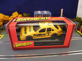 Yellow scale model car box featuring a Mercedes AMG C-Class for SCX C.699