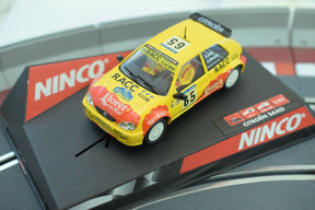 Yellow slot car replica of a Citroen Saxo race car on a track base for Ninco 50266