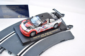 Slot car of a 2001 BMW M3 GTR race car on a display base for Fly Car 99001, front view