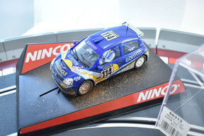 Blue race car model with "Go!!!!" text, dirt effect, on a display base for Ninco 50313