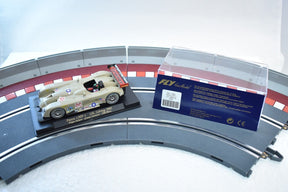 Model race car on track with product information card for Fly Car A222