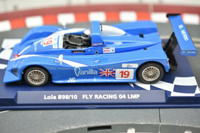 Blue race car model, Lola B98/10 Fly Racing 04 LMP, on a checkered base for Fly Car 07051