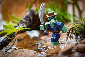 Roblox figure resembling a crocodile stands in shallow, natural water for UCC 10816