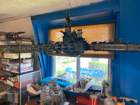 Large Lego ship model suspended over a display of bricks and sets