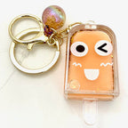 Cute, smiling face keychain charm with a round, iridescent bead accent for BC Mini 12063