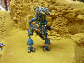 Blue and green robot action figure standing on yellow textured surface for Robogear 6007