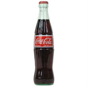 Dark soda beverage in a glass bottle with a red and white label for Coca-Cola 00463