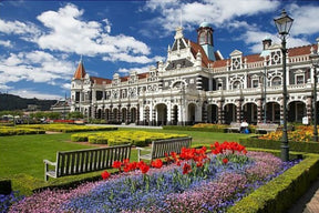 Grand historic station facade with colorful flower beds and green lawn for PuzzleLife PLF832