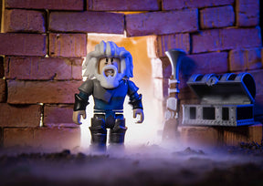 Roblox figure with white beard stands before a mine entrance with mining cart for UCC 00403