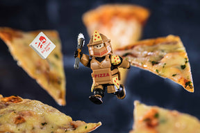 Action figure pizza warrior suspended above slices of pizza for UCC 00404