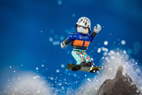Action figure snowboarding mid-air against a blue, snowy backdrop for UCC 00407