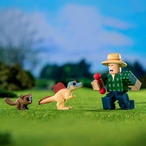 Toy keeper with toy dinosaur and small pet on green grass for UCC 43059