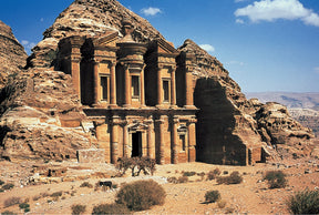 Rock-cut facade of ancient tomb in Petra, Jordan under blue sky for Tomax TOM100-154