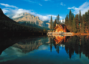 Cabin reflected in calm water with mountains and forest backdrop for Tomax TOM50-045