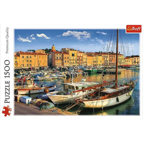 Colorful buildings line a busy harbor in Saint Tropez with docked boats for Trefl TRF26130