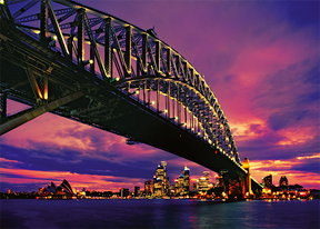 Sydney Harbour Bridge spans the water at sunset over the city skyline for Trefl TRF37103