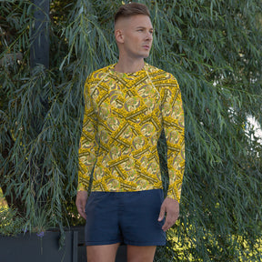 Man wearing a yellow patterned rash guard and dark shorts outdoors for 9551523_9326, front view