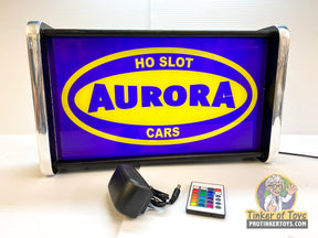 Illuminated sign displaying "HO SLOT AURORA CARS" for slot cars for QEC