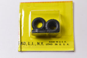 Two small, black rubber tires displayed on a yellow card for Aurora Model Motoring 8372-15
