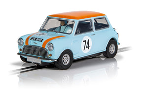 Light blue Mini Cooper slot car with orange roof and number 74 decal for Scalextric C4325