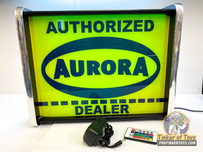 Neon sign reading "AUTHORIZED AURORA DEALER" with accompanying electronics for QEC