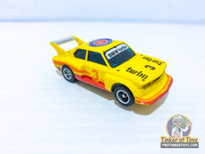 Yellow and red toy slot car, BMW 320i Turbo model for Aurora AFX 1979-82BMWi