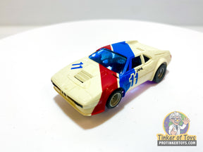 White and blue slot car, BMW M1 style, with number 11 for Aurora AFX 1957