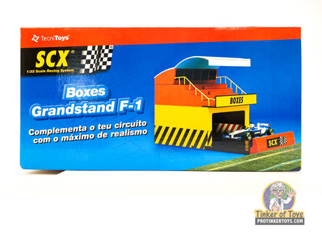 Scale model display for F-1 racing, featuring grandstands and pit boxes for SCX 88260
