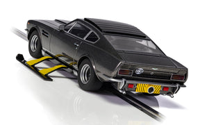 Black Aston Martin V8 slot car on a track for Scalextric C4239