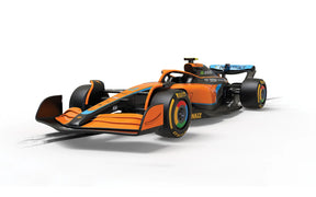 Orange and black McLaren race car model on a track base for Scalextric C4424