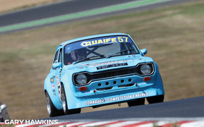 Blue Ford Escort MK1 race car driving on a track for Scalextric C4445