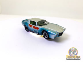 Silver and green toy Camaro car, front view, on white surface for Tyco TYTRICKCF7172