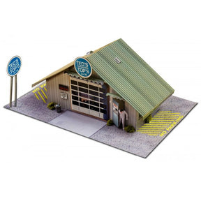Model kit of a small, detailed garage building with signage for Innovative Hobby Supply BK3210